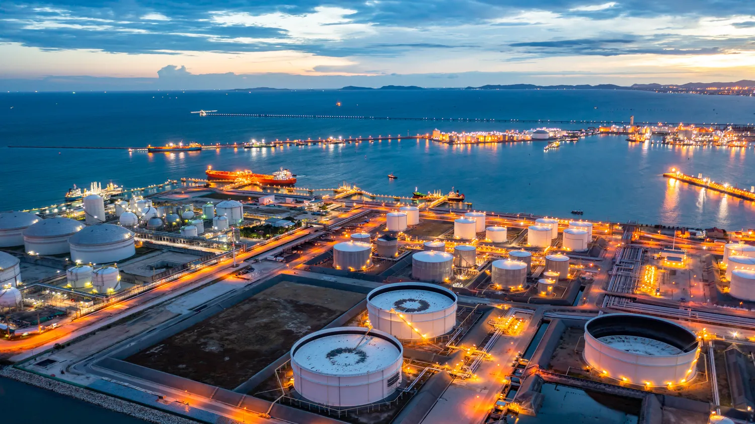 Aerial view of industrial chemical storage facility at twilight